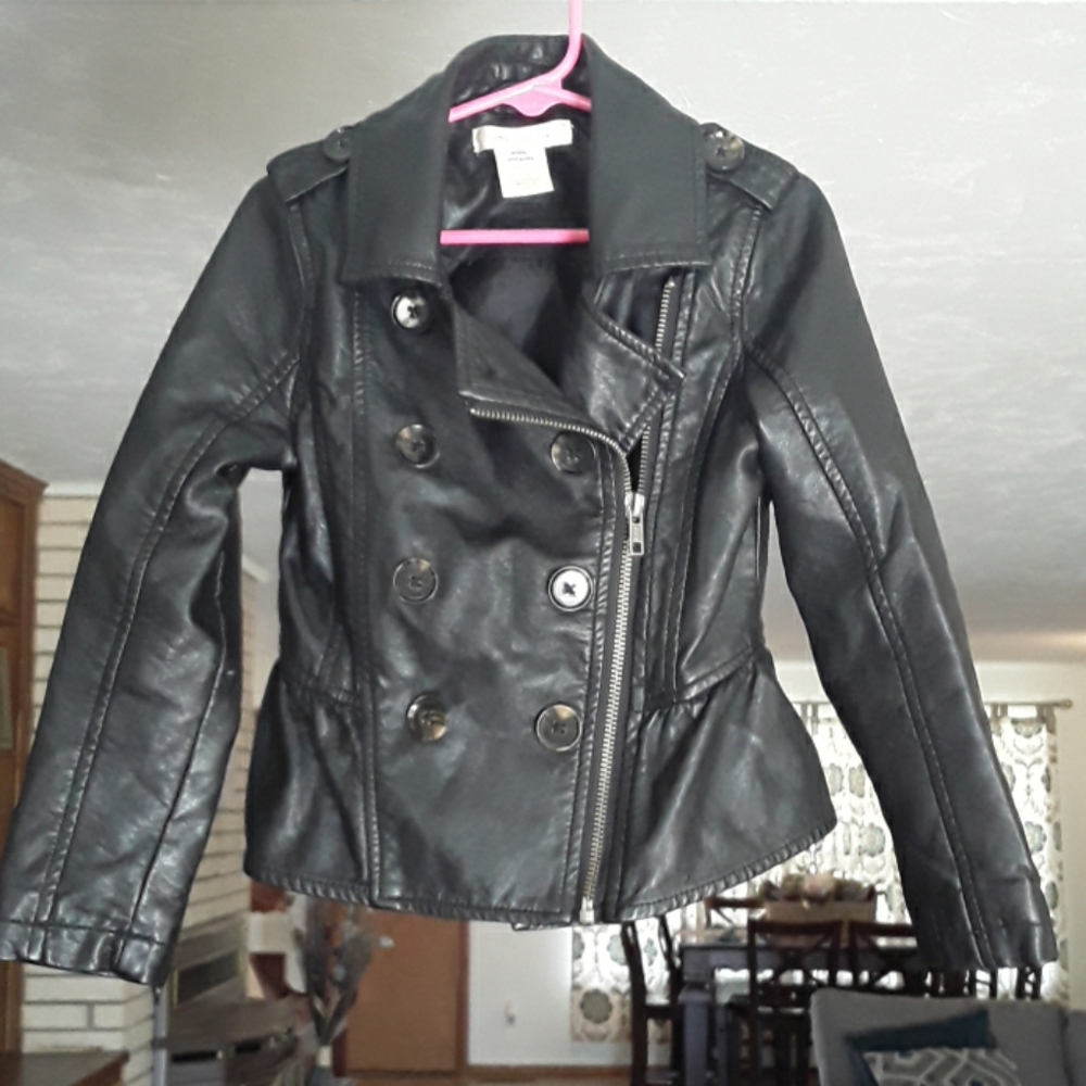 Black faux leather, zipper, ruffle in the back